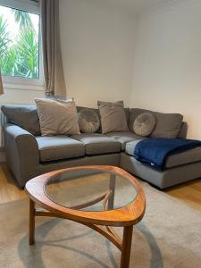 a living room with a couch and a coffee table at Garden Flat in London