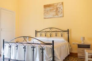 a bedroom with a bed with a metal frame at casa vacanza Noctua in Galatina