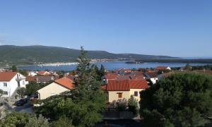 a view of a town with a lake and houses at Apartman Z12 in Kornić