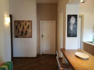 a dining room with a wooden table and a door at Casa Beatrice in Castiglioncello