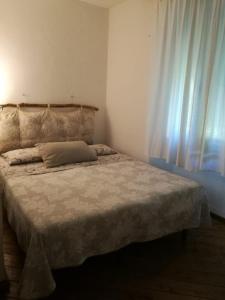 a bedroom with a large bed with a window at Casa Beatrice in Castiglioncello