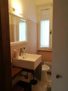 a bathroom with a white sink and a toilet at Casa Beatrice in Castiglioncello