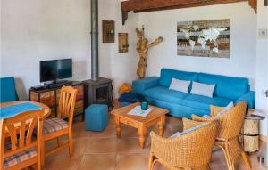 a living room with a blue couch and a table at Nice Home In Escales With House A Panoramic View in Escales