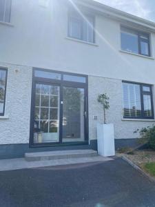 a white building with a large glass door on it at Beautiful one bedroom Apartment In Galway City in Galway