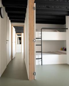 a room with a bunk bed and a hallway at Vista del Mar Japandi in Koksijde