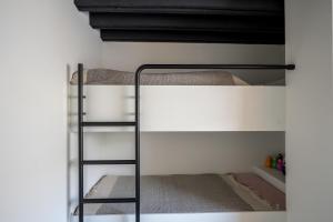 a bunk bed in a room with a ladder at Vista del Mar Japandi in Koksijde +6 photos