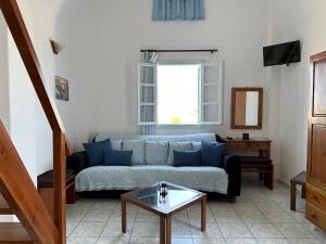 a living room with a couch and a table at Hotel Paradisos Oia in Oia