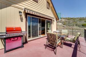 a patio with a grill and a table and chairs at South Lake Tahoe Home with Deck and Gas Grill! in South Lake Tahoe