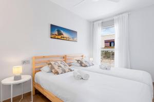Łóżko lub łóżka w pokoju w obiekcie MEDANO4YOU Cabezo Residence