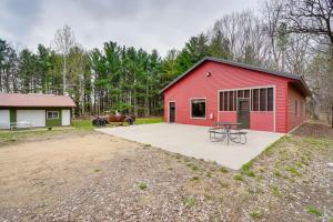 a red barn with a picnic table in front of it at Pet-Friendly Cabin Retreat Walk to Lake Pepin! in Stockholm