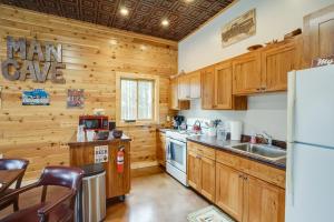 a kitchen with wooden cabinets and a refrigerator at Pet-Friendly Cabin Retreat Walk to Lake Pepin! in Stockholm
