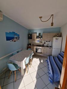 a kitchen with a table and chairs and a refrigerator at Casamarina Orchidea in Campomarino +12 photos