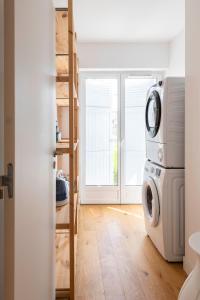 een wasruimte met een wasmachine en droger bij Villa Acacias - Au coeur de Saint-Tropez in Saint-Tropez