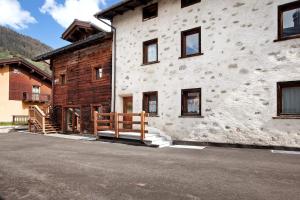 a white building with a wooden fence next to it at Appartamenti Elisabetta n2 in Livigno