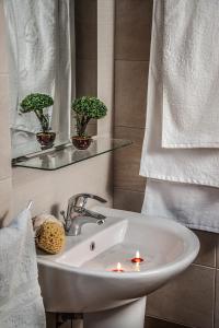 a bathroom with a sink with candles in it at Symi Filoxenia in Symi