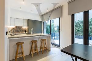 a kitchen with a black table and stools at X Flats in Istanbul