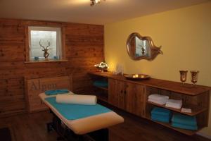 a bathroom with a sink and a mirror at AlpenLodge Allgäu 5* in Ofterschwang