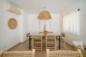 a dining room with a table and chairs at Boho Chic Beach Duplex in Sesimbra