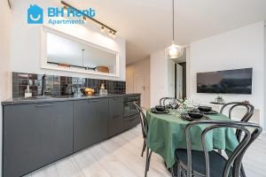 cocina y comedor con mesa y sillas en BH Rent Apartments, Gdańsk Krynicka 2, SoHo en Gdansk