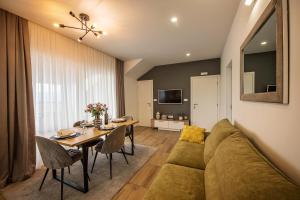 a living room with a couch and a table at Apartman I & J in Imotski