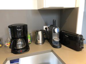 a kitchen counter with a coffee maker and a toaster at La loge des Salinières in Bordeaux