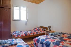a bedroom with two beds and a window at Vikendica Luka 