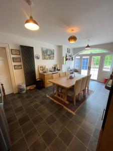 a kitchen and dining room with a table and chairs at The Cottage at Riverbank in Ballinamallard