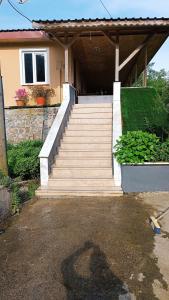 a staircase leading to a house with a porch at Arslan KONAGI in Rize