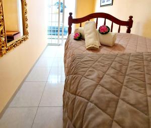 a bedroom with a bed with flowers and a mirror at Adeje House 2 bedrooms, Wifi Free in Adeje