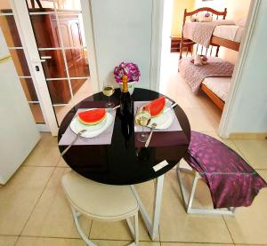 a black table with two chairs and a table with fruit on it at Adeje House 2 bedrooms, Wifi Free in Adeje +10 photos
