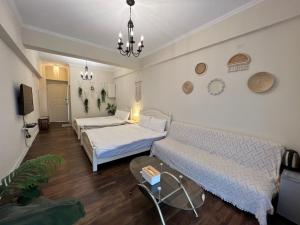 a living room with two beds and a couch at 海沐輕旅 Sea Mu Kenting in Nanwan