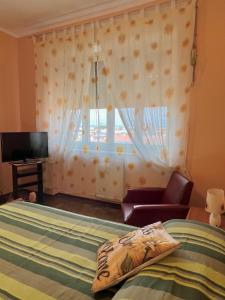 - une chambre avec un lit et une fenêtre avec une télévision dans l'établissement Vicino a tutto, à Verceil