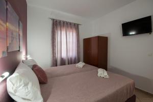 Postel nebo postele na pokoji v ubytování MARIHELEN APARTEMENTS
