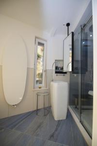 a white kitchen with a table and a window at Oldwell Hotel in Santa Domenica +55 photos