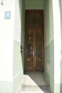 a wooden door in a building with a hallway at Apartamenty Rynek X in Przemyśl