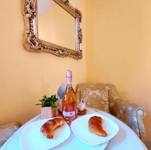 a table with two plates of pastries and a bottle of wine at SMALL APARTMENT, Adeje House Wifi Free in Adeje
