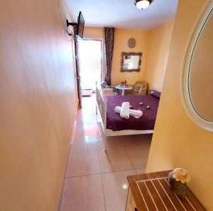 a small room with a bed and a mirror at SMALL APARTMENT, Adeje House Wifi Free in Adeje +6 photos