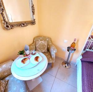 a living room with a table with two plates of food at SMALL APARTMENT, Adeje House Wifi Free in Adeje