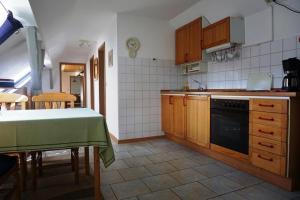 a kitchen with a table and a stove top oven at Haus Kunert 