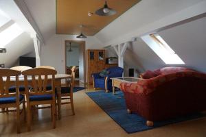 a living room with a table and chairs at Haus Kunert 