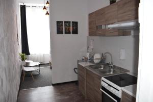 a small kitchen with a sink and a stove at Apartamenty Rynek X in Przemyśl