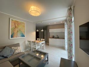 a living room with a couch and a table at Apartamenty Silence Blue Baltic in Pobierowo