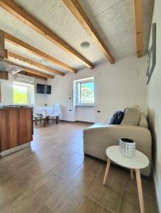 a living room with a couch and a table at Apartments Sveti Ivan in Mošćenička Draga