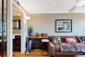 a living room with a couch and a table at Rehoboth Beach --- Star of the Sea #604 in Rehoboth Beach