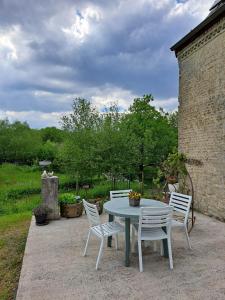 a table and chairs sitting on a patio at Chez Caro in Epinois