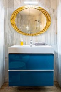 a bathroom with a blue sink and a mirror at La casa de Jacobo in Seville