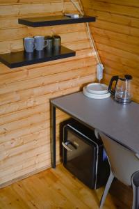 a table in a tiny house with plates on it at Mtskheta Cabin in Mtskheta