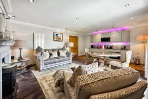 a living room with two couches and a kitchen at Skyfall Glencoe at Creag an-t Sionnaich in Glencoe