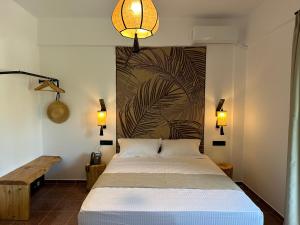 a bedroom with a bed and a wall with a mural at Armeno Resort in Marathias