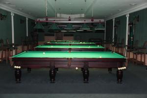 a row of pool tables in a room at Kleopatra VIP hotel in Kamianets-Podilskyi